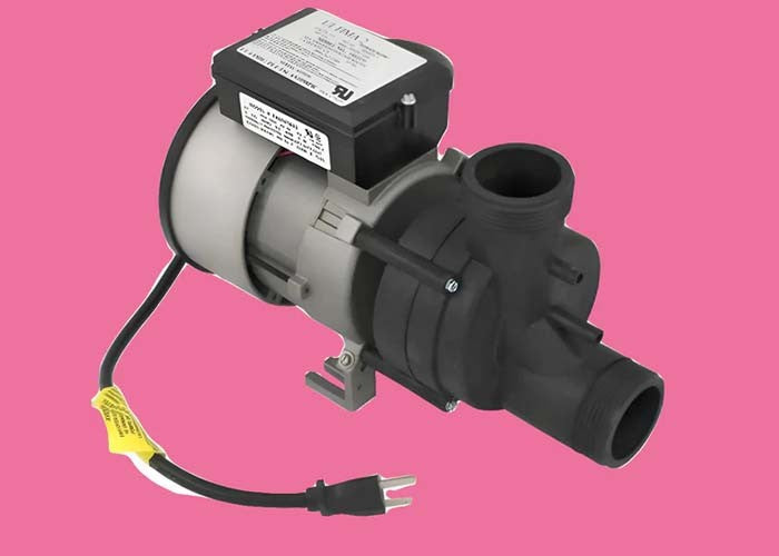 Black and gray Whirlpool jetted tub pump with power cord on a pink background