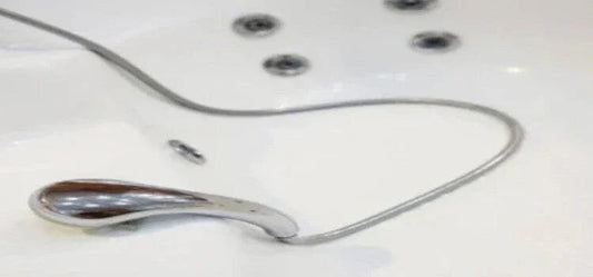 Close-up of Whirlpool jet tub replacement part and chrome handle inside white jetted bathtub