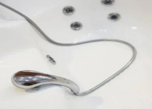 Whirlpool jetted tub with chrome replacement parts, jets, and flexible shower hose