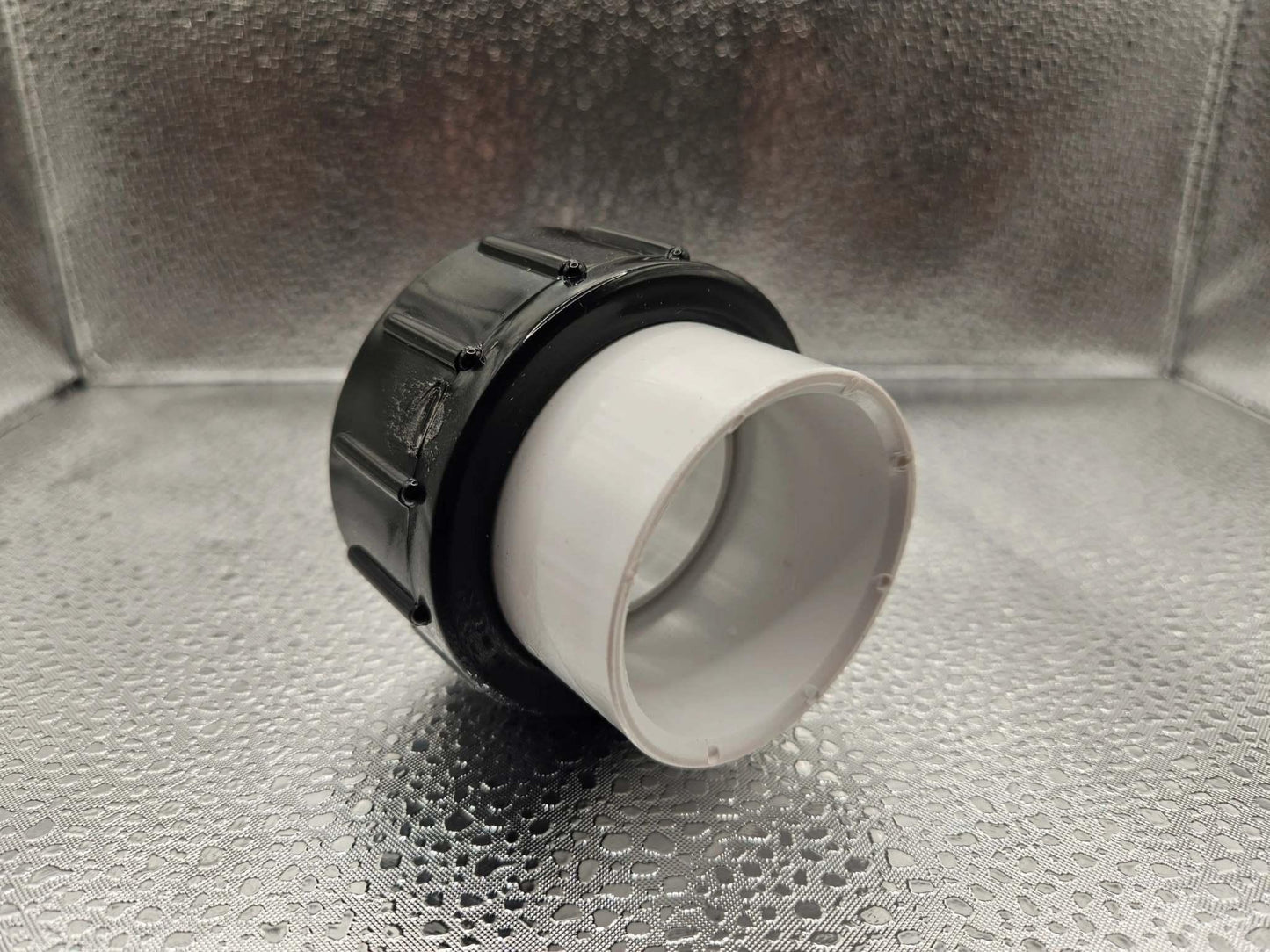 White Balboa Water Group Ultima 1.5-inch pump union for hot tubs and spas, featuring durable white plastic construction.