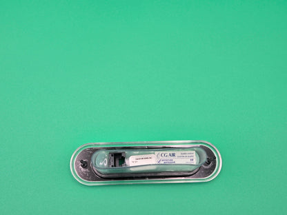 Small electronic device with a label on a green background